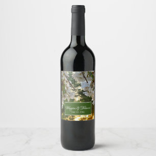 White flowering tree buds sunrise thru pine trees wine label