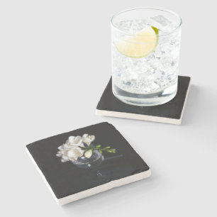 white freesia in a glass stone coaster