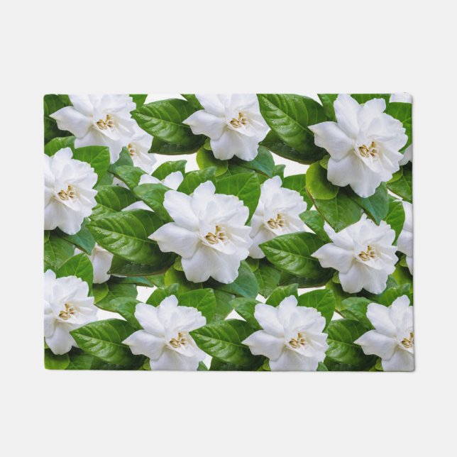 White gardenia flowers and green leaves on green doormat (Front)