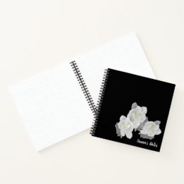 White Gardenia Flowers on Black Notebook