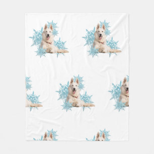 White German Shepherd laying in the Snowflakes Fleece Blanket