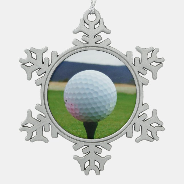 white Golf Ball on a mountain golf course Snowflake Pewter Christmas Ornament (Front)