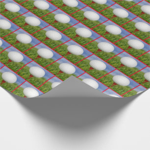 white golf ball on red tee wrapping paper