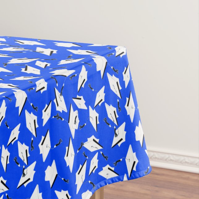 White Graduation Caps on Bright Blue Tablecloth (In Situ)