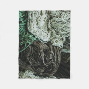 White, gray, and green ropes fleece blanket