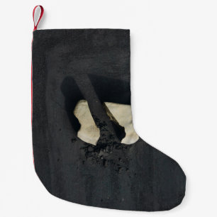 White heart shaped on black surface small christmas stocking