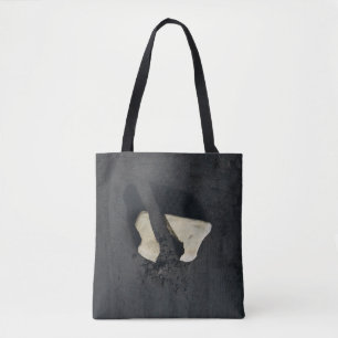 White heart shaped on black surface tote bag