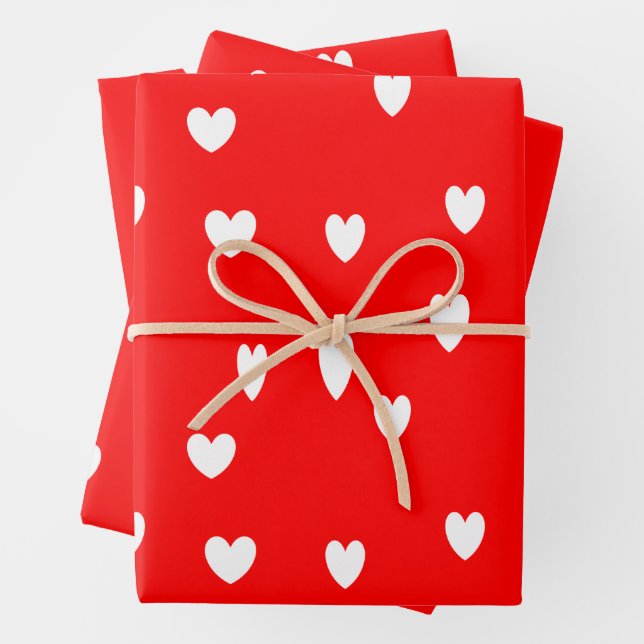 White hearts pattern on red wrapping paper sheet (In situ)
