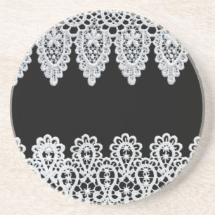 White lace forms a delicate border against black coaster