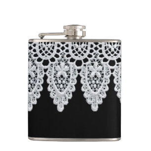 White lace forms a delicate border against black hip flask