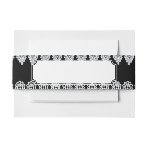 White lace forms a delicate border against black invitation belly band