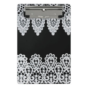 White lace forms a delicate border against black mini clipboard