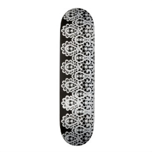 White lace forms a delicate border against black skateboard