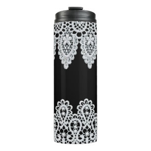 White lace forms a delicate border against black thermal tumbler