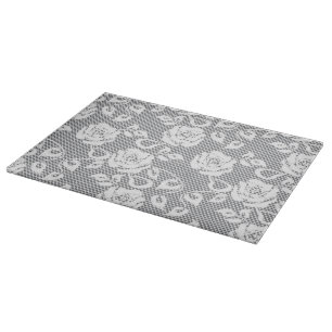 White lace pattern on grey background cutting board