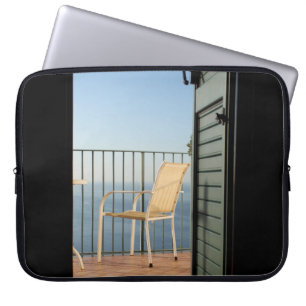 White metal armchair beside fence in the morning laptop sleeve