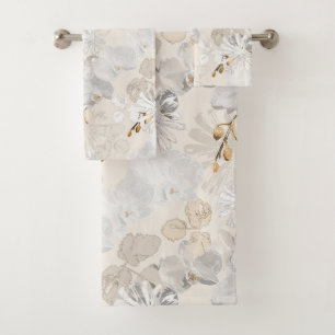 White orchids on a light cream bath towel set