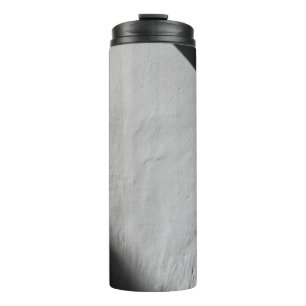 WHITE PAINTED WALL WITH BLACK TEXTILE THERMAL TUMBLER
