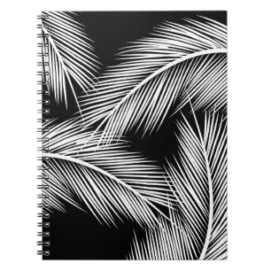 White palm leaves on black colour background notebook
