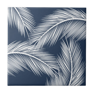 White palm leaves on dark blue colour background tile