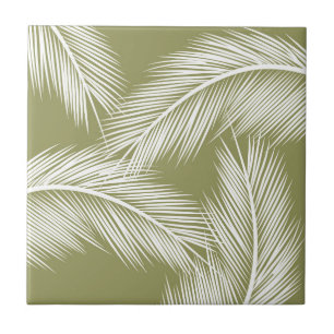 White palm leaves on green colour background tile