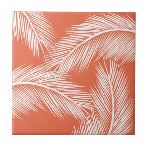 White palm leaves on salmon colour background tile
