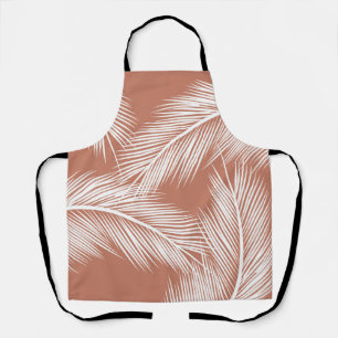 White palm leaves on terracotta colour background apron