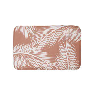 White palm leaves on terracotta colour background bath mat