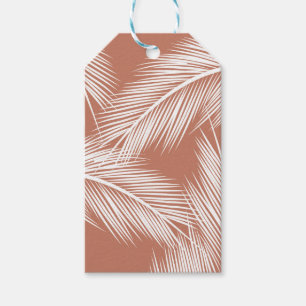 White palm leaves on terracotta colour background gift tags
