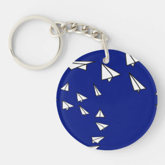 White paper planes on blue key ring