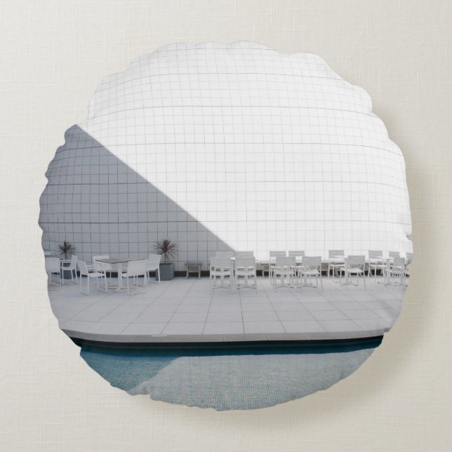 WHITE PATIO TABLE WITH CHAIRS DURING DAYTIME ROUND CUSHION (Front)