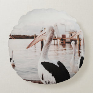 WHITE PELICAN ON BODY OF WATER DURING DAYTIME ROUND CUSHION