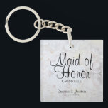 White Peonies Maid of Honour Wedding Favour Key Ring<br><div class="desc">This beautiful keychain is perfect for thanking your Maid of Honour. Designed as a part of our White Reflections Wedding Suite, it features black text over a background of reflecting white flowers and hearts. The text is fully customisable and reads: Maid of Honour, with a place for her name, the...</div>