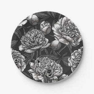 White peony flowers on dark gray paper plate