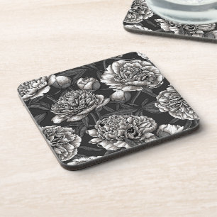 White peony flowers on dark grey coaster