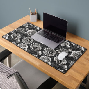 White peony flowers on dark grey desk mat