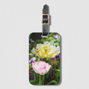White, pink and yellow tulips in the garden luggage tag