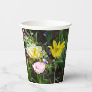 White, pink and yellow tulips in the garden paper cups