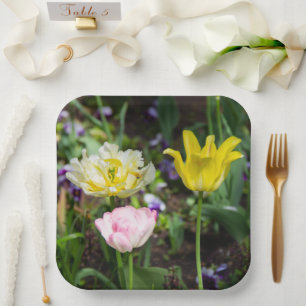 White, pink and yellow tulips in the garden    paper plate
