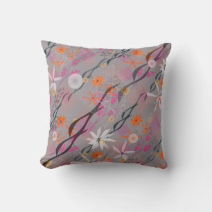 White, pink, orange flowers on grey cushion