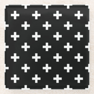 White polka crosses on black glass coaster
