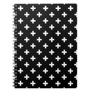 White polka crosses on black notebook