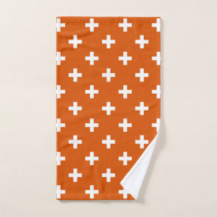 White polka crosses on burnt orange hand towel