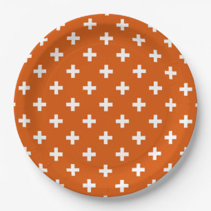 White polka crosses on burnt orange paper plate
