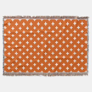 White polka crosses on burnt orange throw blanket