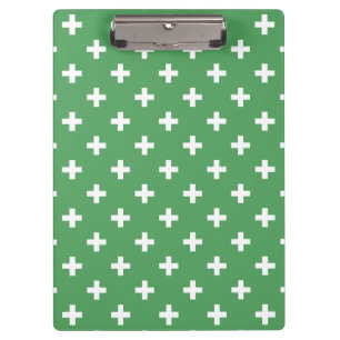 White polka crosses on green clipboard