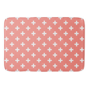 White polka crosses on peach bath mat