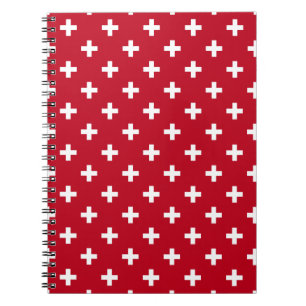White polka crosses on red notebook