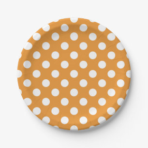 White polka dots on amber paper plate