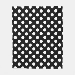 White polka dots on black fleece blanket